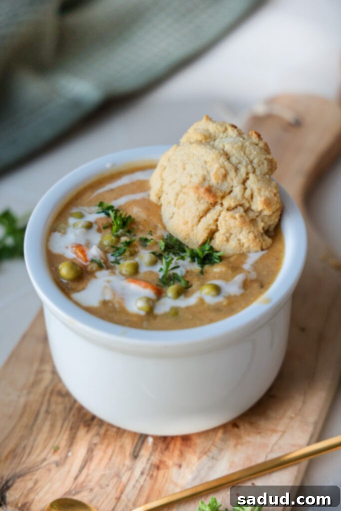 A beautifully presented bowl of creamy chicken pot pie soup, ready to be enjoyed.