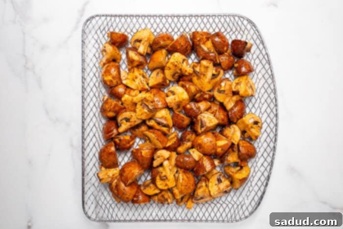 Marinated mushrooms resting on a air fryer tray