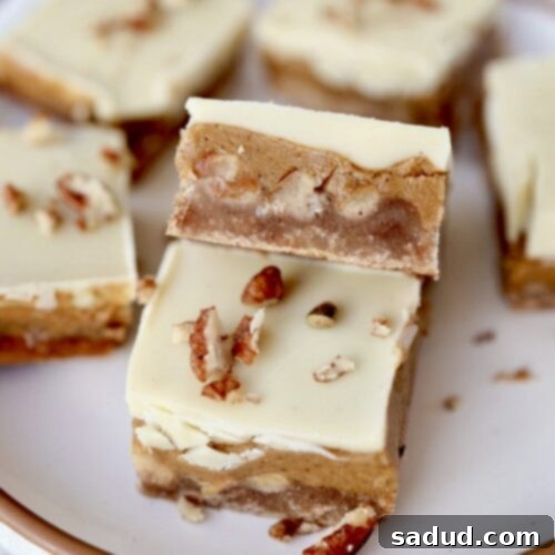 Close-up of a caramel apple bar showing the distinct layers of shortbread, caramel apple filling, and white chocolate.