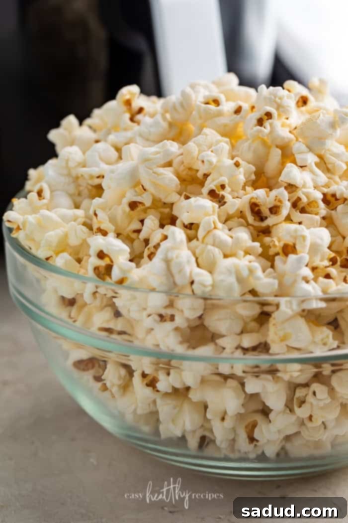 Air fryer popcorn in a glass bowl