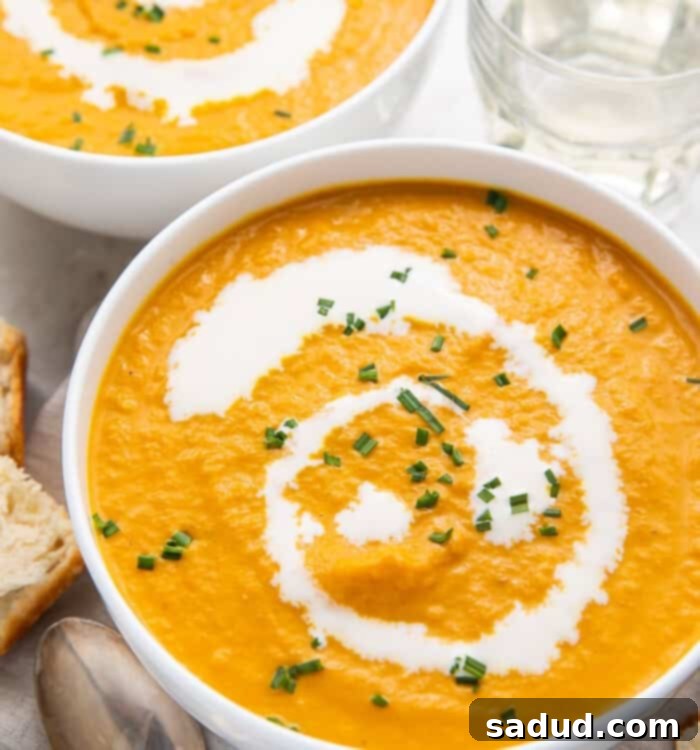 A vibrant bowl of homemade pumpkin bisque, garnished with fresh herbs, ready to be served.