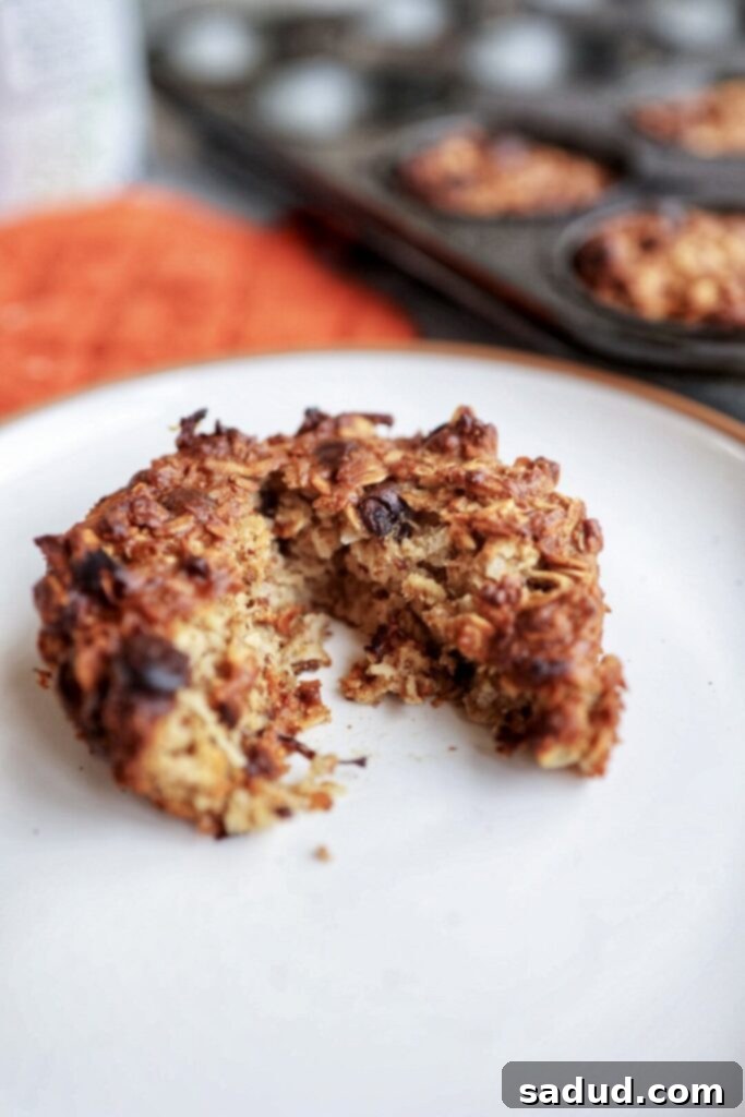 An oatmeal cup cut in half, revealing its moist texture and chocolate chunks.