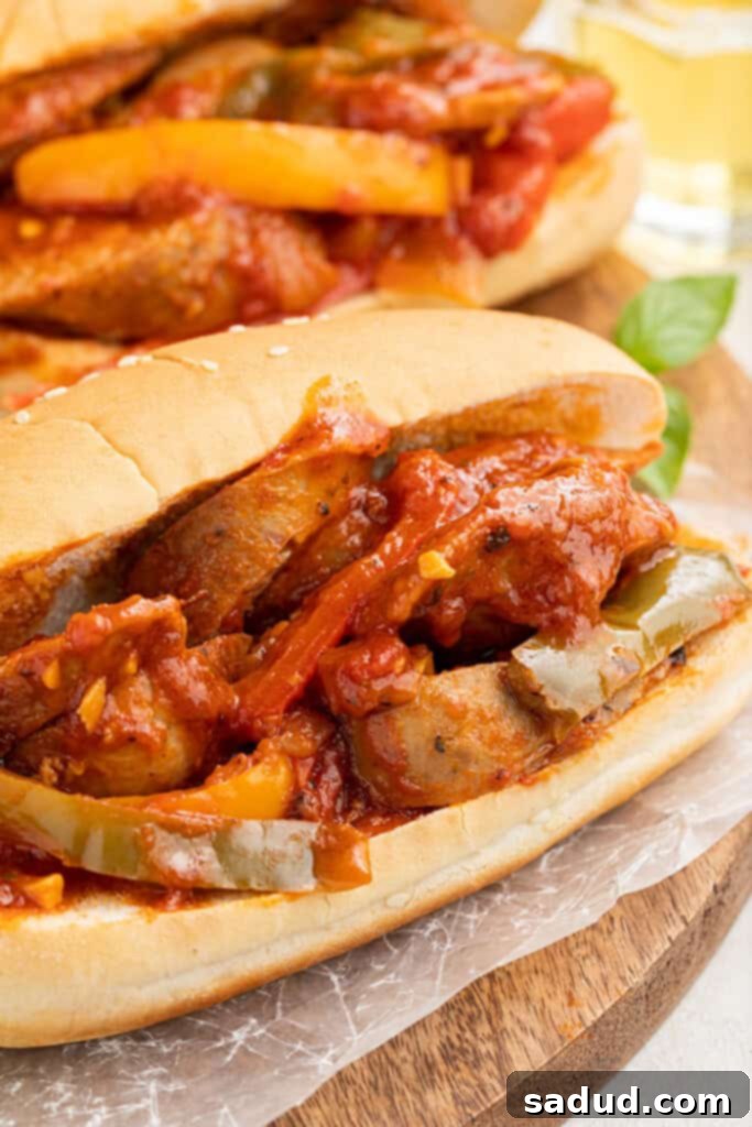 Two generously filled sandwiches with vibrant Instant Pot sausage and peppers, showcasing the rich tomato sauce and colorful vegetables, ready to be served.