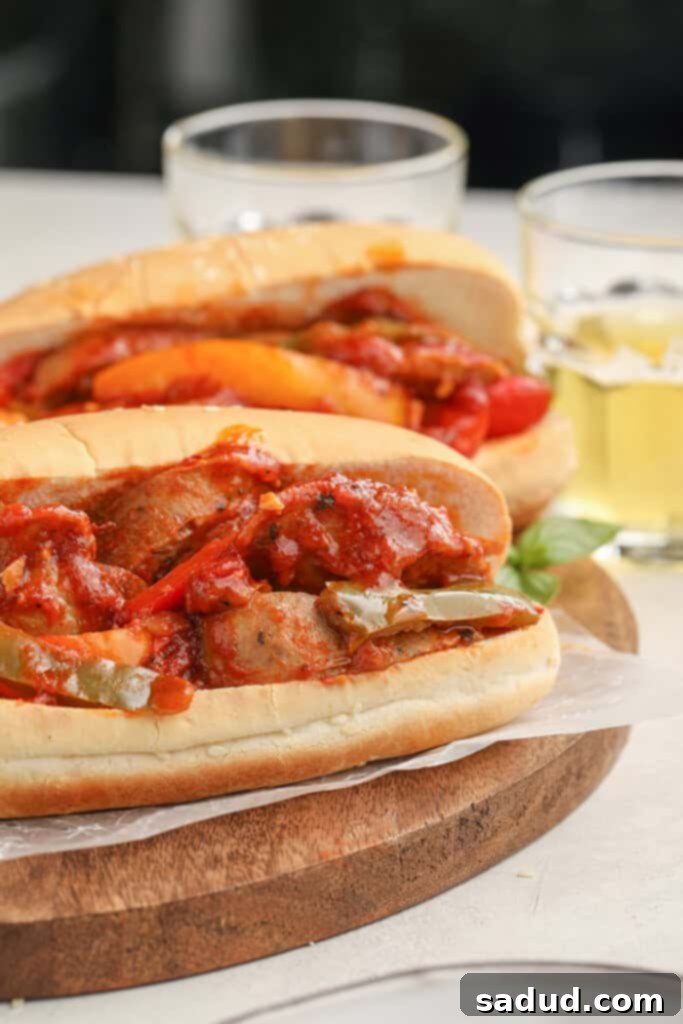 Instant Pot sausage and peppers served in two robust Italian hero sandwiches, highlighting the rich filling and crusty bread, perfect for a hearty meal.