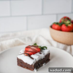 Fudgy paleo brownies with strawberries and whipped cream.