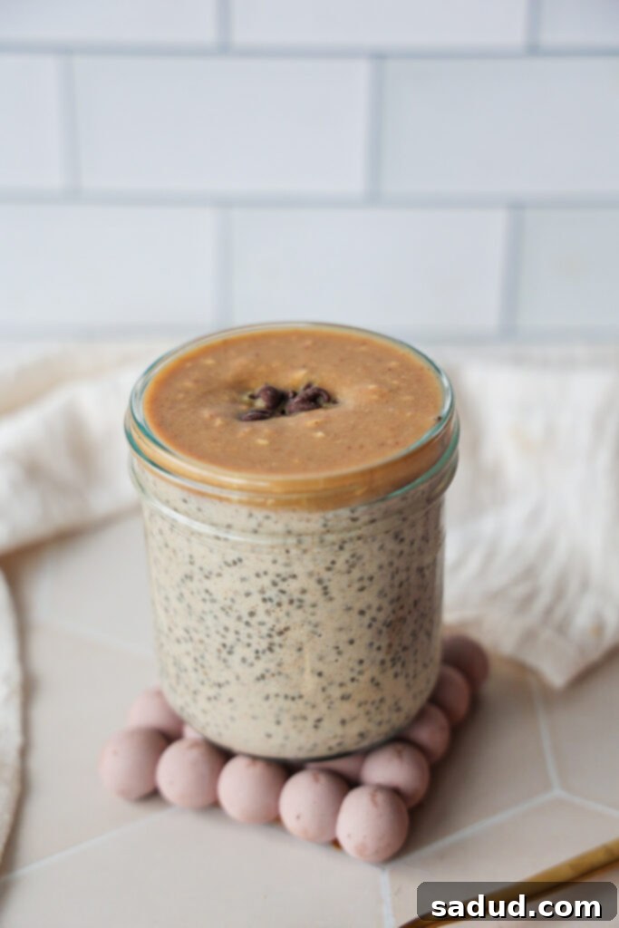 A jar of creamy chia seed pudding with peanut butter magic shell.