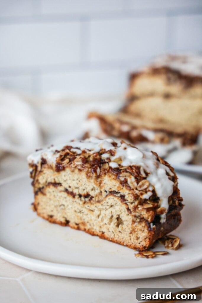 A beautifully baked loaf of cinnamon swirl banana bread, showing the streusel topping and a hint of the swirl.