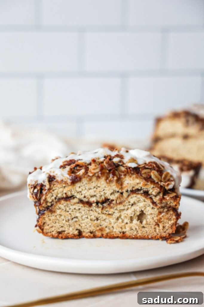 A delectable slice of cinnamon swirl banana bread, showing the moist interior, the cinnamon ribbon, and the streusel.