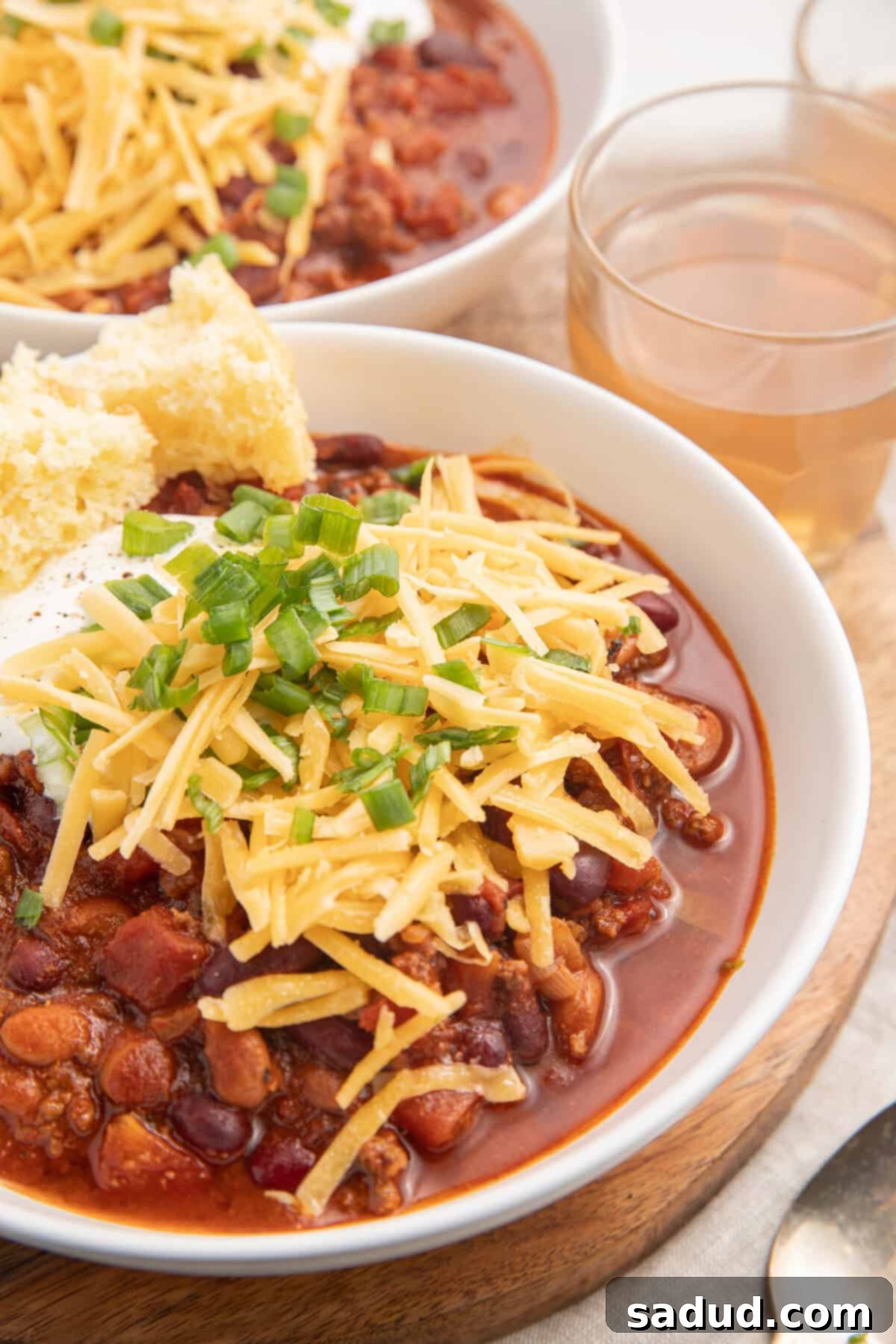 Two bowls of bison chili topped with cheese