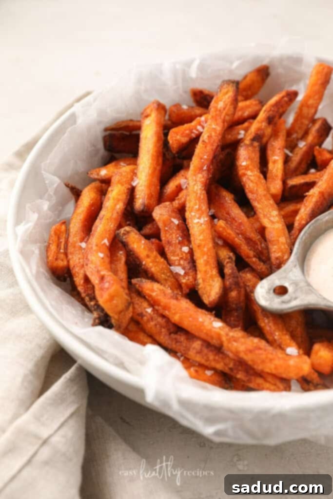 Crispy Air Fryer Sweet Potato Fries from Frozen 2 Crispy air fryer sweet potato fries with salt in a white bowl