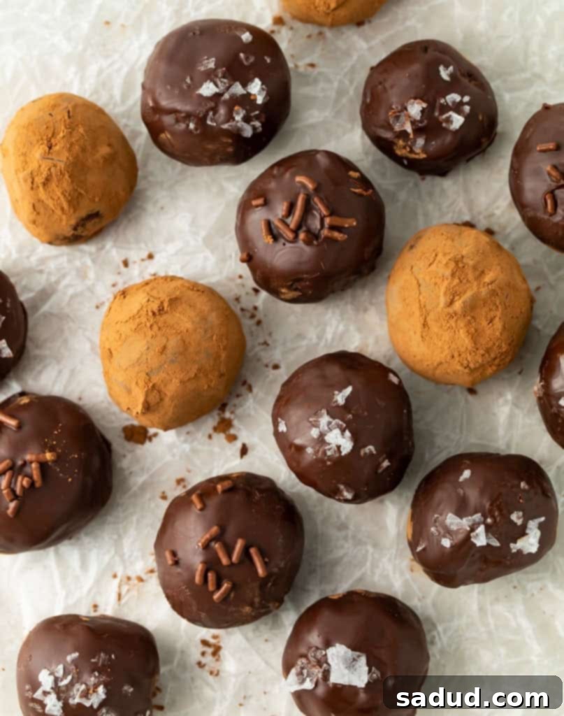 Keto Chocolate Delights 5 Keto chocolate truffles garnished with cocoa powder, sea salt, and sugar-free chocolate sprinkles