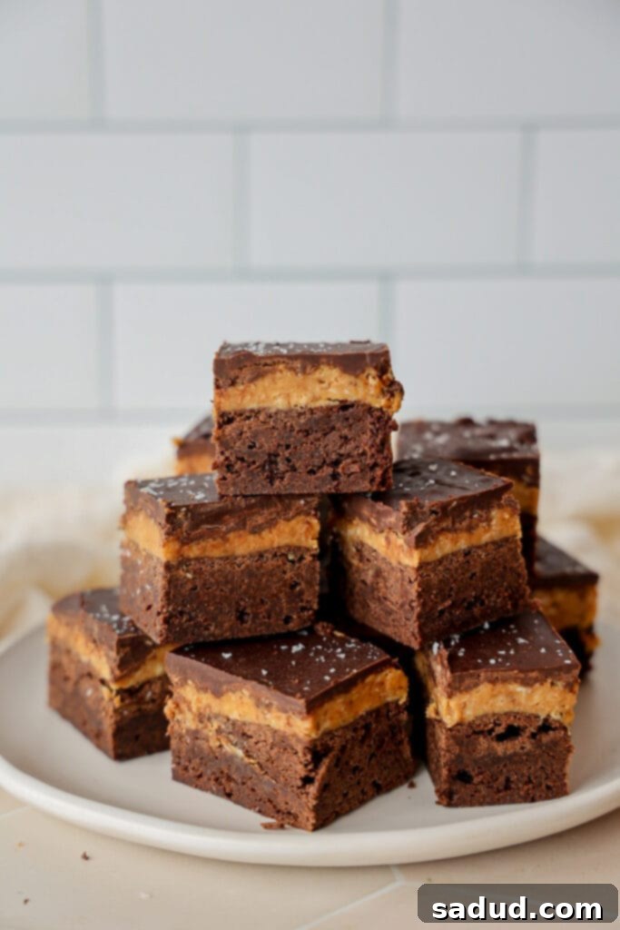 A stack of coconut brownies, showing their rich, fudgy texture.