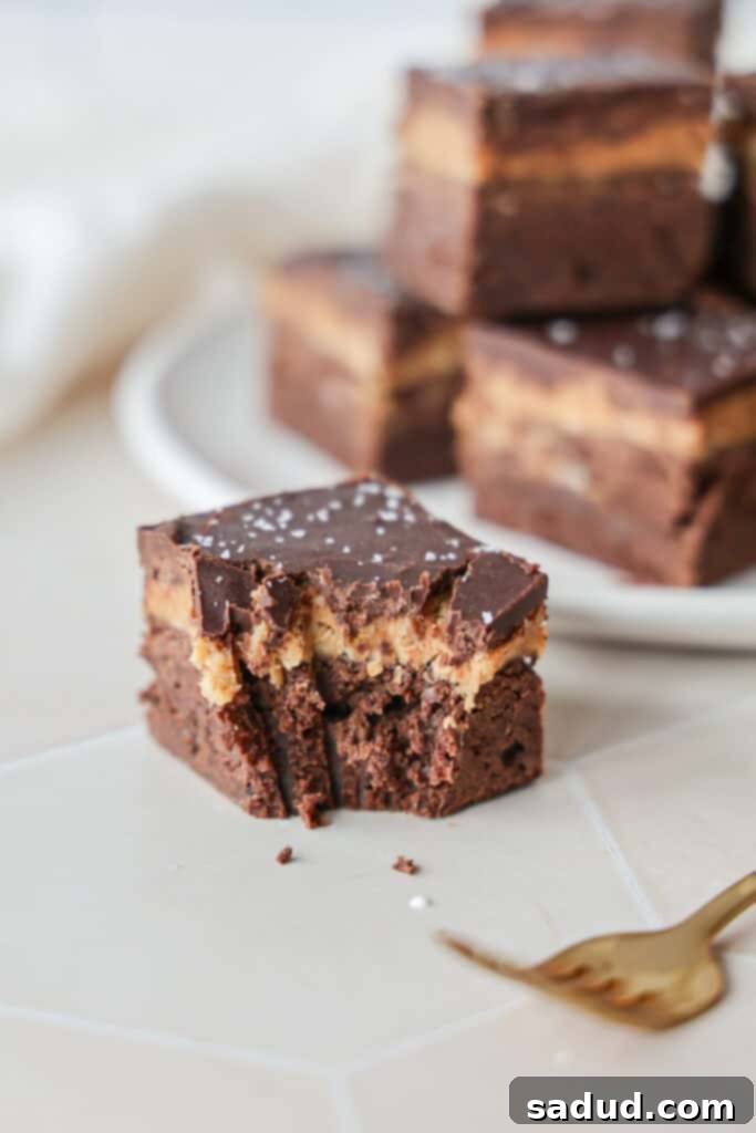 A layered coconut brownie, showing its distinct layers.