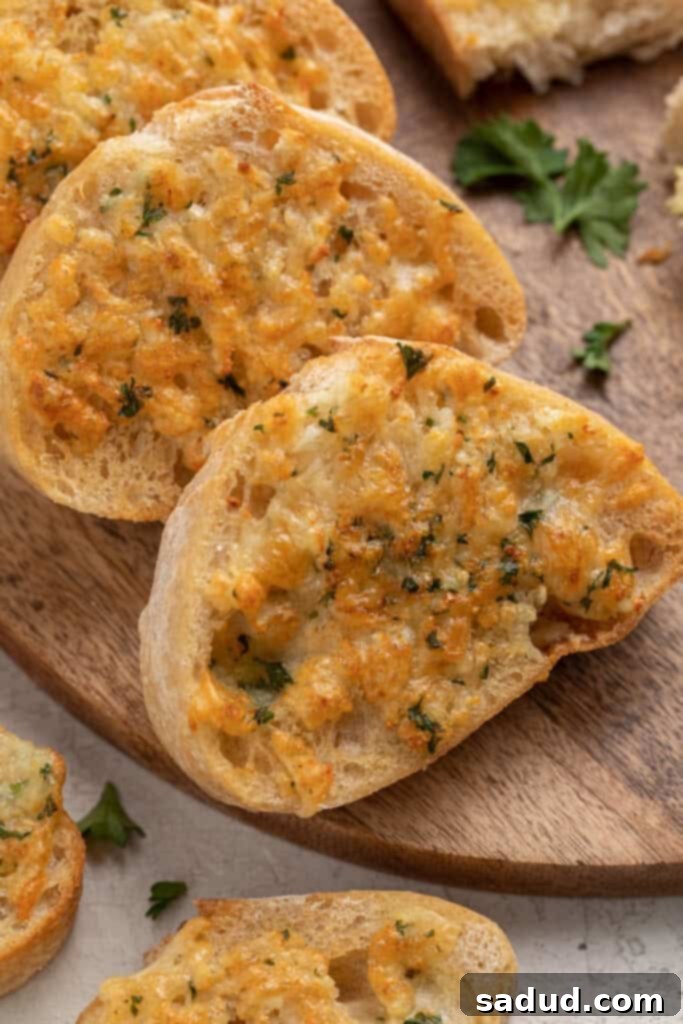Crispy Air Fryer Garlic Bread 2 Slices of air fryer garlic bread arranged on a wooden cutting board