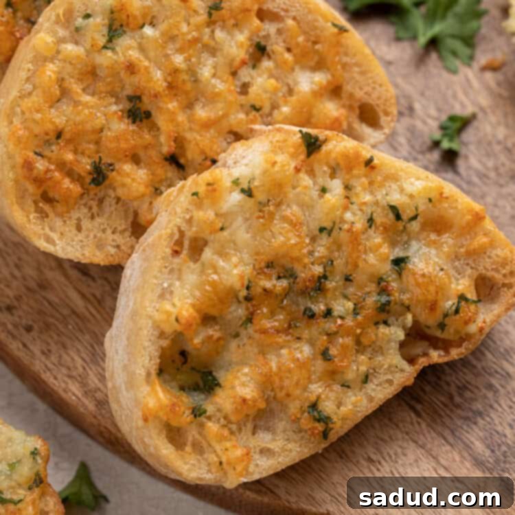 Crispy Air Fryer Garlic Bread 4 Slices of air fryer garlic bread arranged on a wooden cutting board