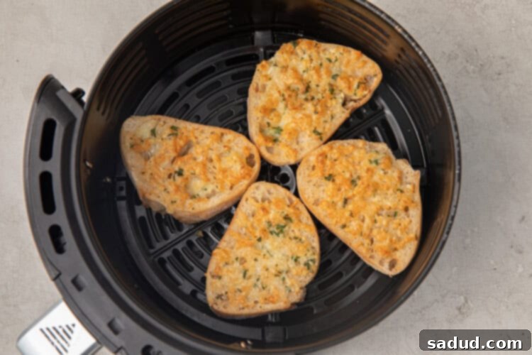 Air fryer garlic bread slices in the basket of an air fryer