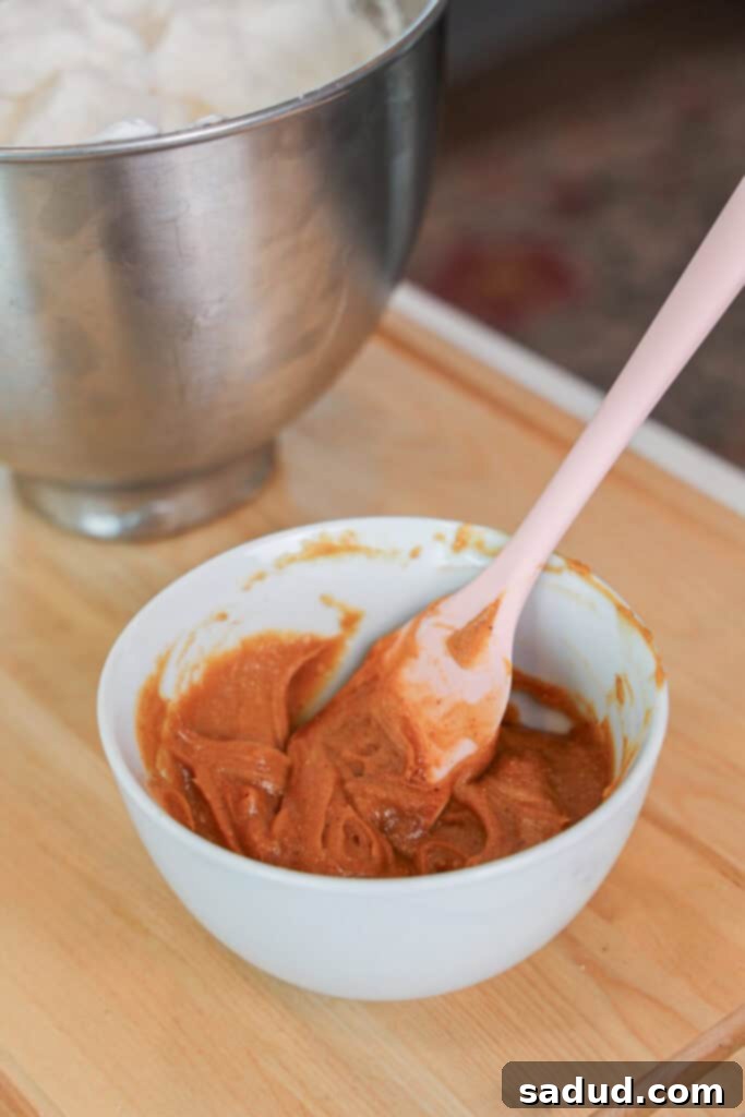 Folding peanut butter mixture into aquafaba.