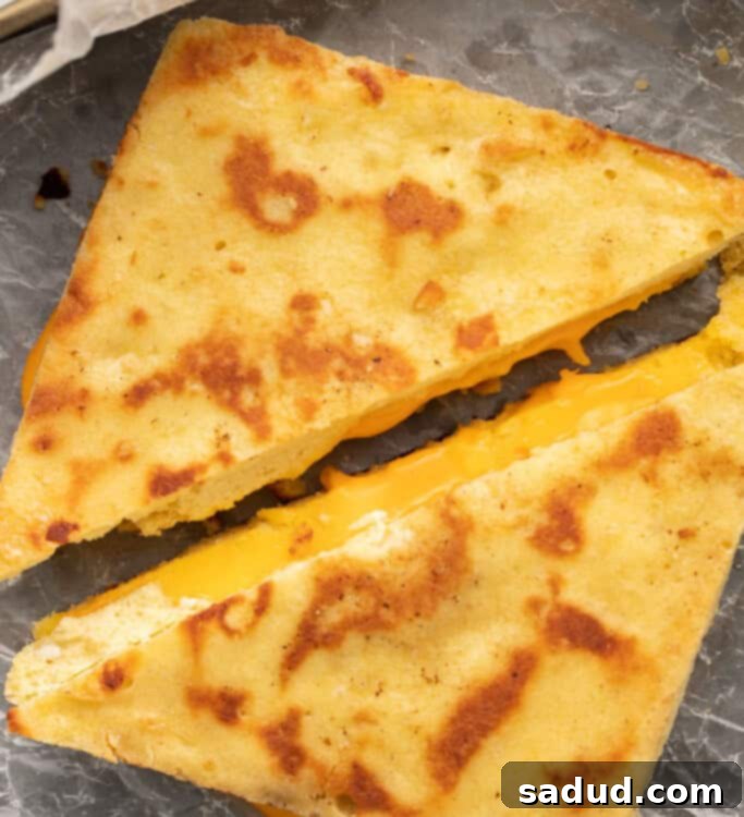 Keto grilled cheese sliced diagonally, served on a plate