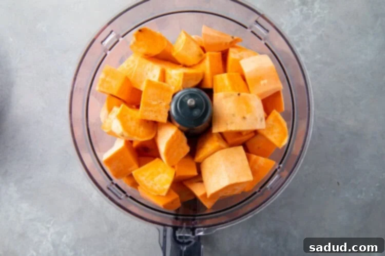 Peeled sweet potatoes in food processor