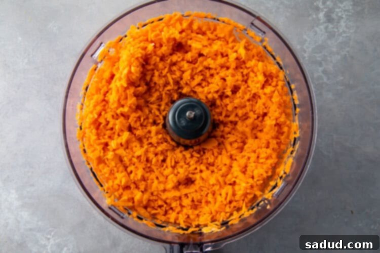 Shredded sweet potato in a food processor bowl