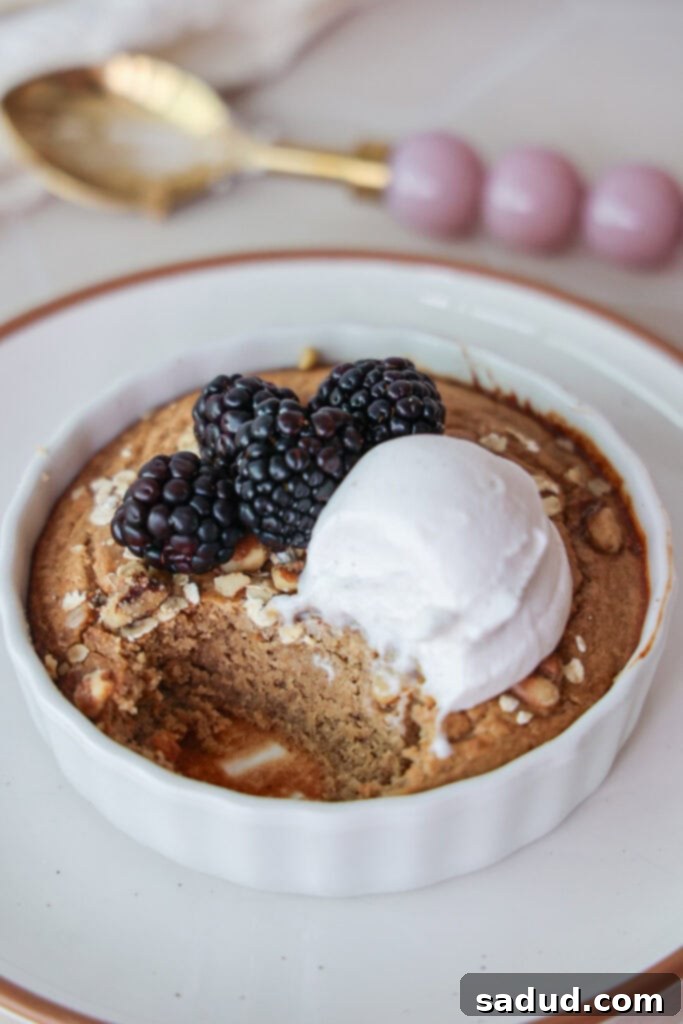 Close-up of protein baked oatmeal without banana, showcasing its cake-like texture, topped with yogurt and fresh berries.