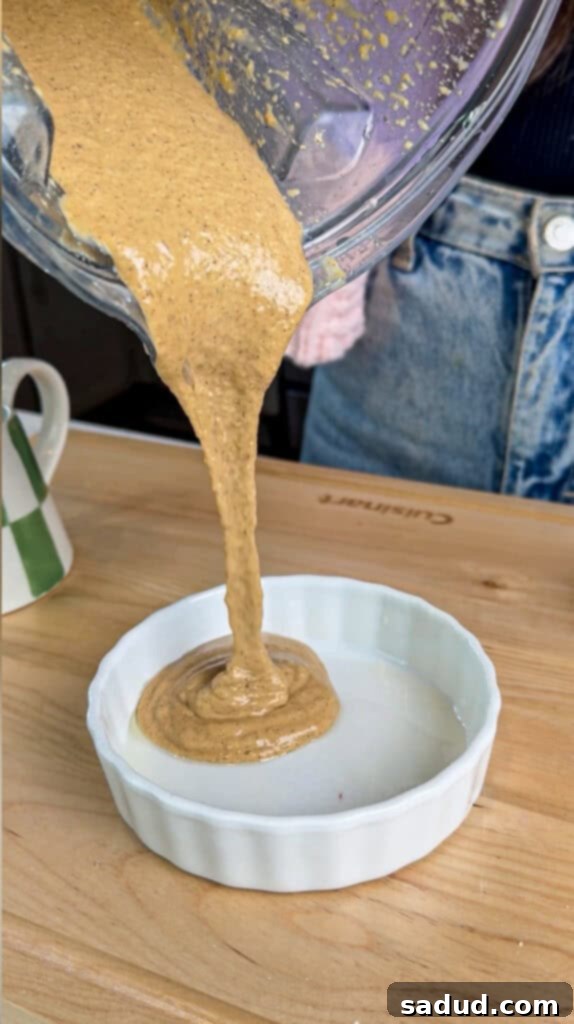 Step-by-step image 1: Adding all ingredients to a blender for protein baked oats.