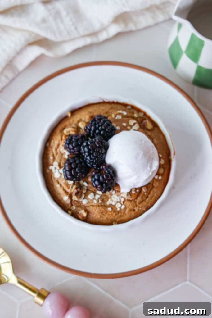 Close-up of a single serving of protein baked oats, garnished with berries, ready to eat.