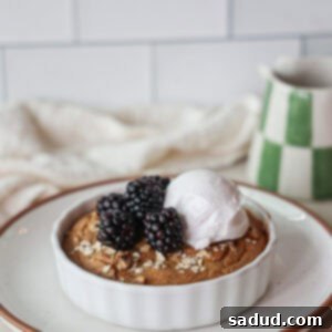Close-up of baked protein oats without banana, topped with fresh berries and yogurt.