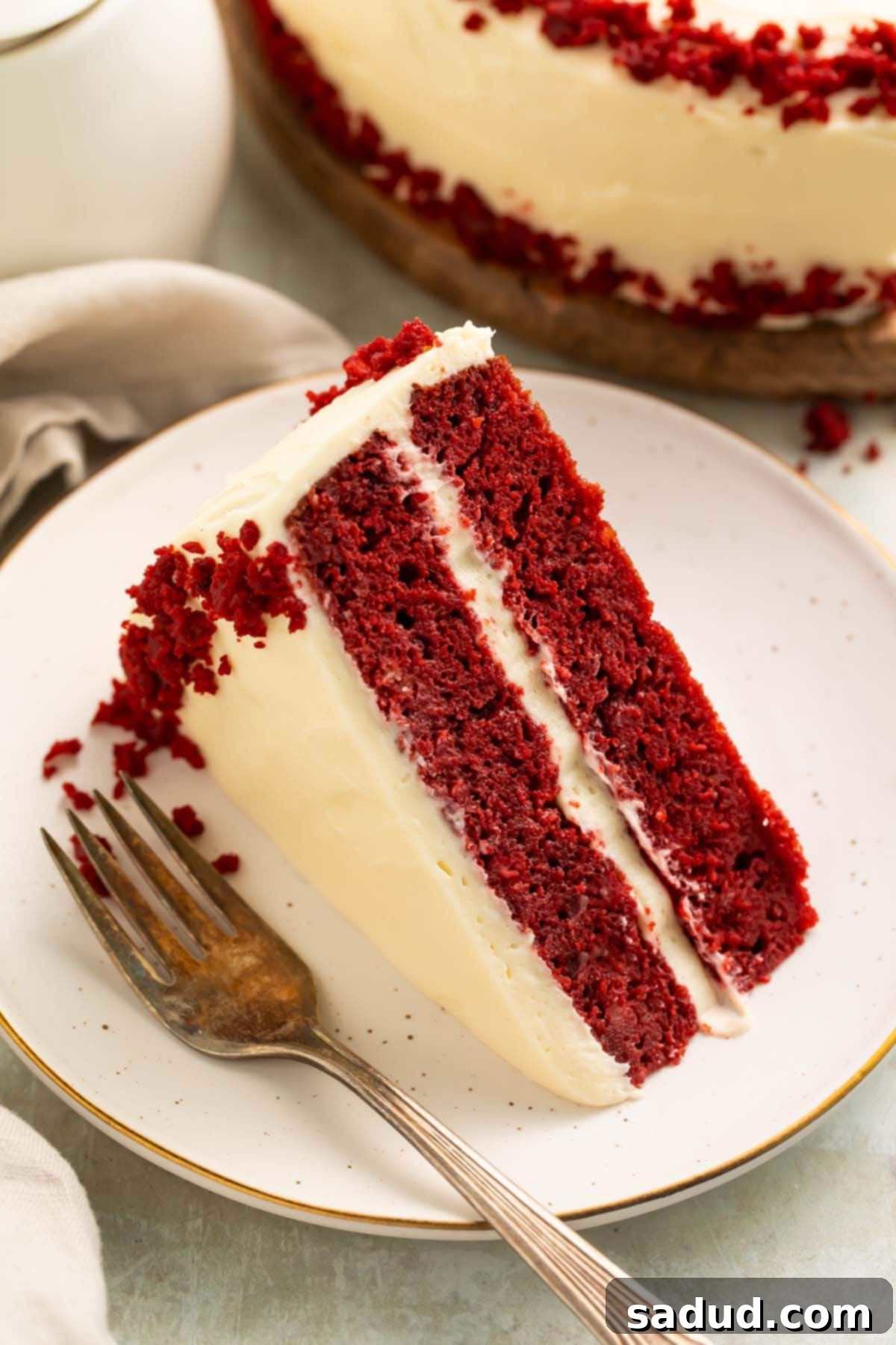 Keto Red Velvet Cake 3 A slice of keto red velvet cake with keto cream cheese frosting on a plate.