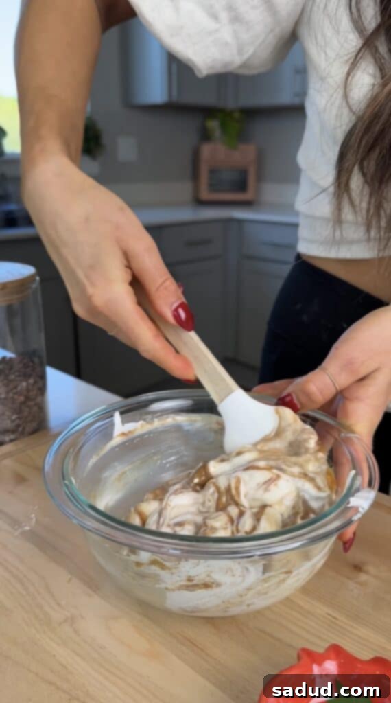 Close-up of a bowl containing the creamy yogurt mixture before freezing, showing its thick consistency.