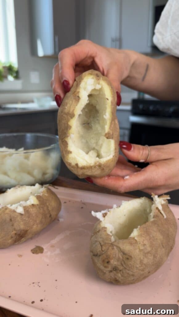 Step-by-step image showing how to scoop out a potato for twice baked.