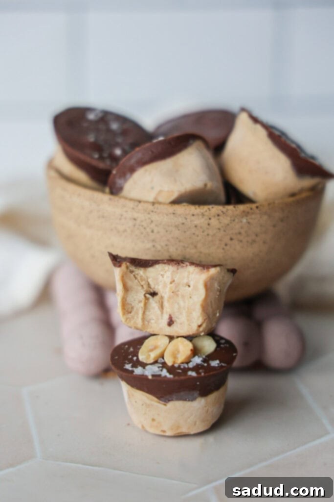 A close-up of a peanut butter Snickers yogurt bite with a bite taken out, showing the creamy interior and date pieces.