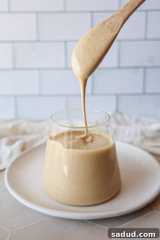 Silken Honey Dream 2 A beautiful glass jar filled with light, fluffy whipped honey, showing its creamy texture and golden hue, ready to be enjoyed.