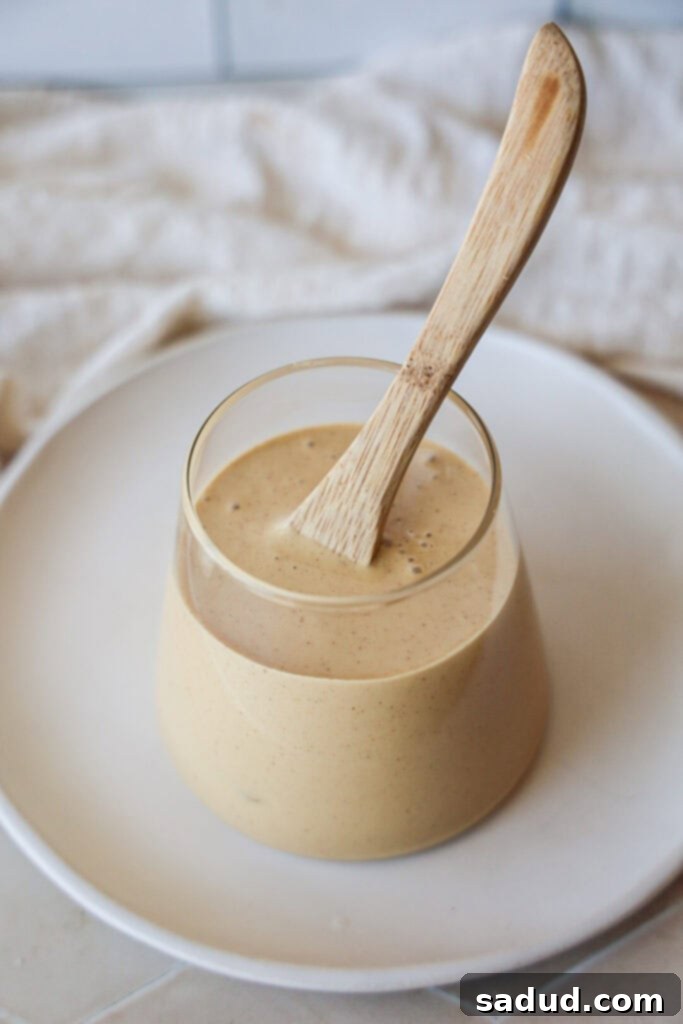 Silken Honey Dream 3 A second close-up view of a jar filled with homemade whipped honey, highlighting its smooth, creamy texture and light golden color.