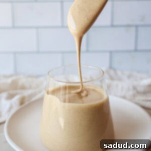 A jar of freshly made whipped honey, golden and creamy, presented as a delicious treat.