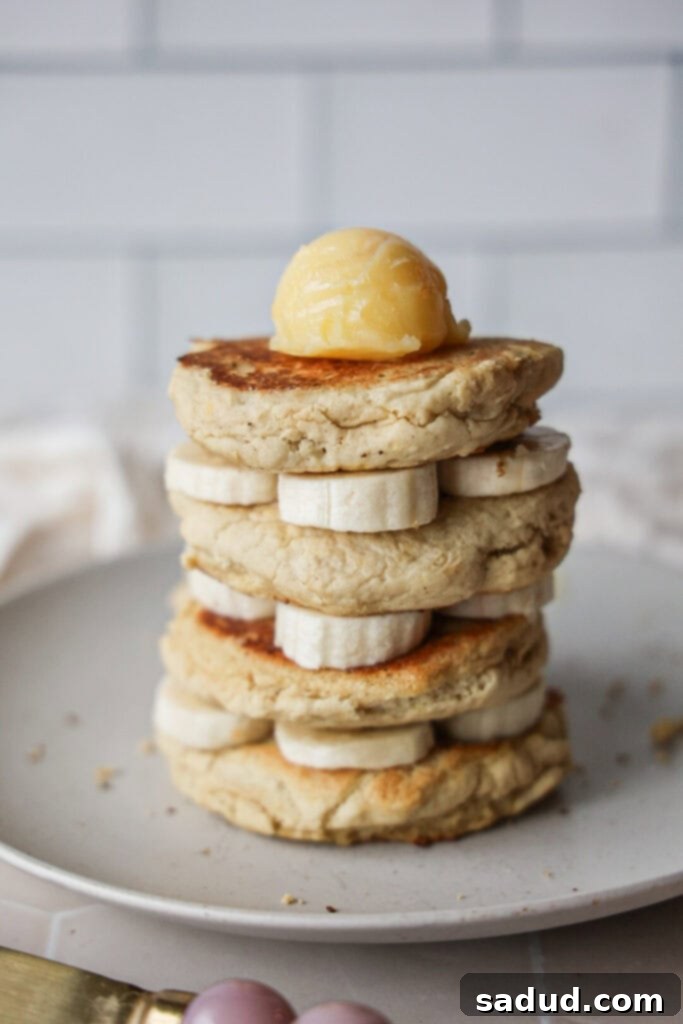 A stack of fluffy, gluten-free, dairy-free, nut-free pancakes with pure maple syrup and butter.