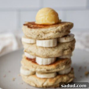 A stack of fluffy, gluten-free, dairy-free, nut-free pancakes with pure maple syrup and butter.