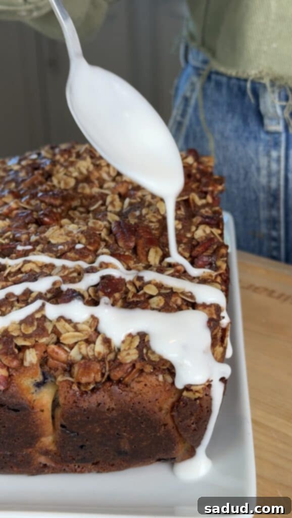 Baked gluten-free blueberry bread with lemon glaze drizzled over.
