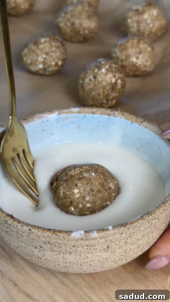 Blending raw cashews, old-fashioned oats, and softened Medjool dates in a food processor to form the no-bake donut hole dough.