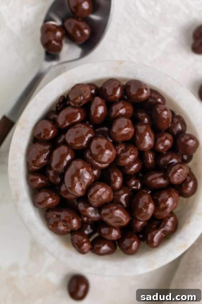 Decadent Espresso Chocolate Bites 2 Chocolate covered espresso beans in a small white bowl next to a silver spoon