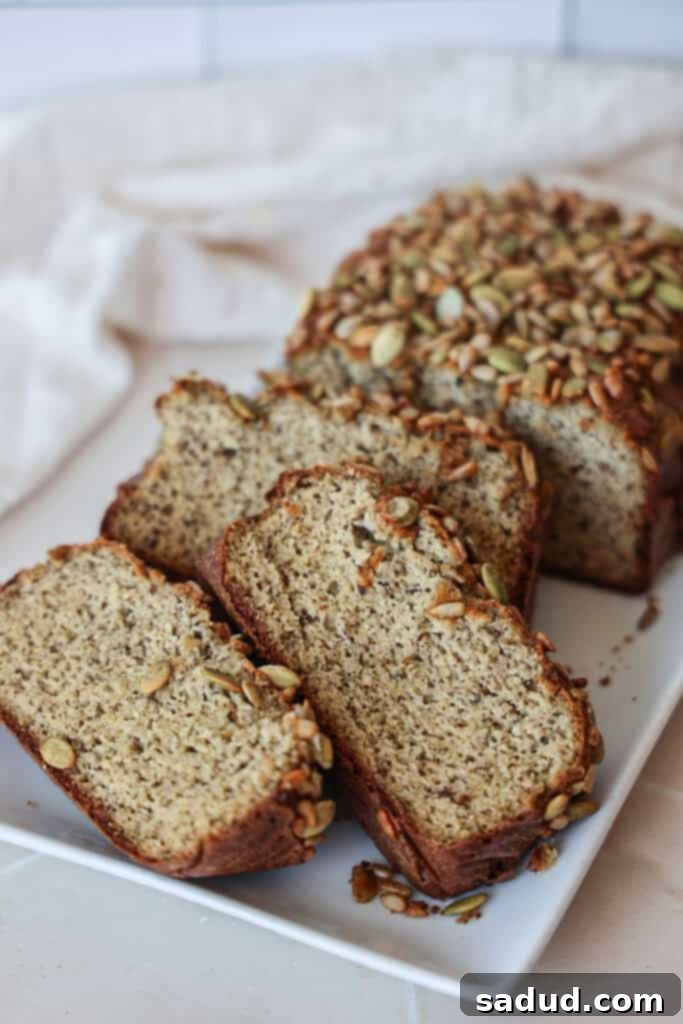 A golden-brown loaf of homemade paleo, gluten-free, dairy-free, grain-free bread, perfect for sandwiches.