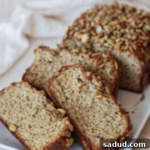 A perfectly baked loaf of Paleo Sandwich Bread, ready to be sliced and enjoyed.