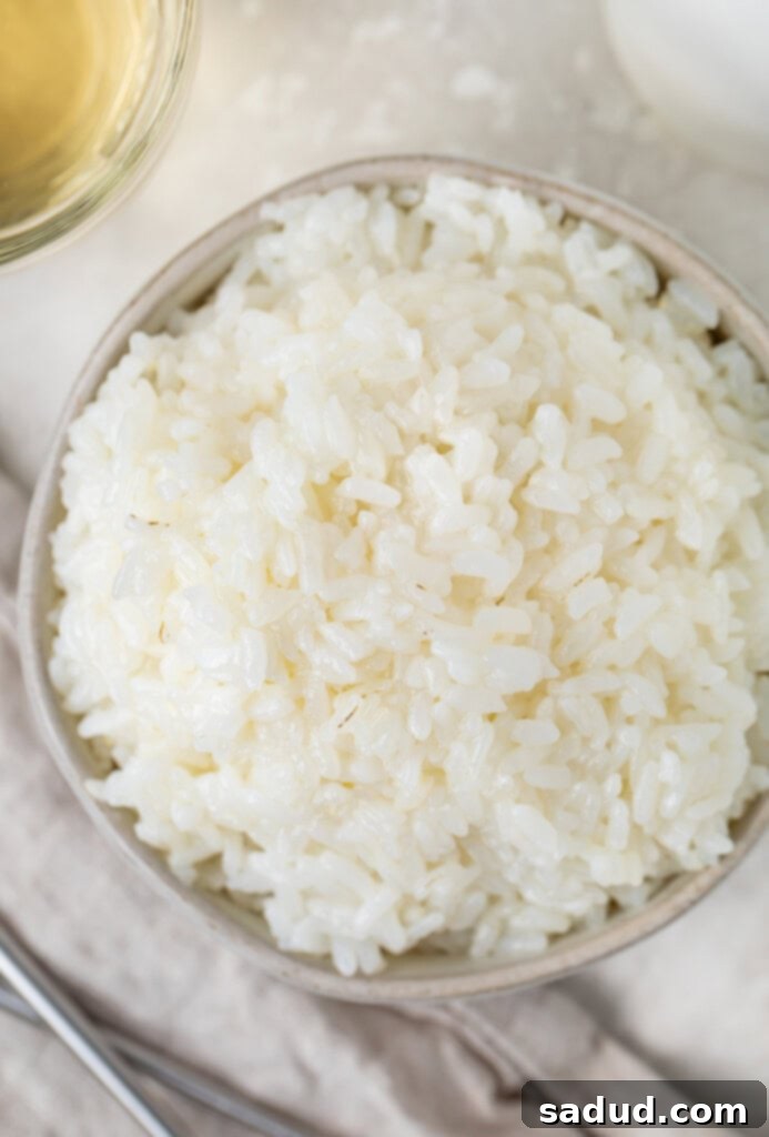 Overhead photo of white sushi rice in a small silver bowl