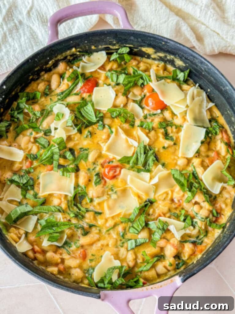 A pot of marry me tuscan beans with vegan parmesan.
