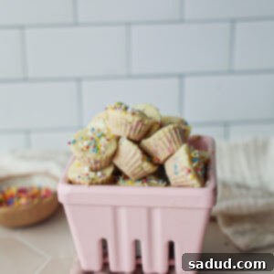 A bowl of delicious Birthday Cake Frozen Yogurt Bites topped with white chocolate and sprinkles.