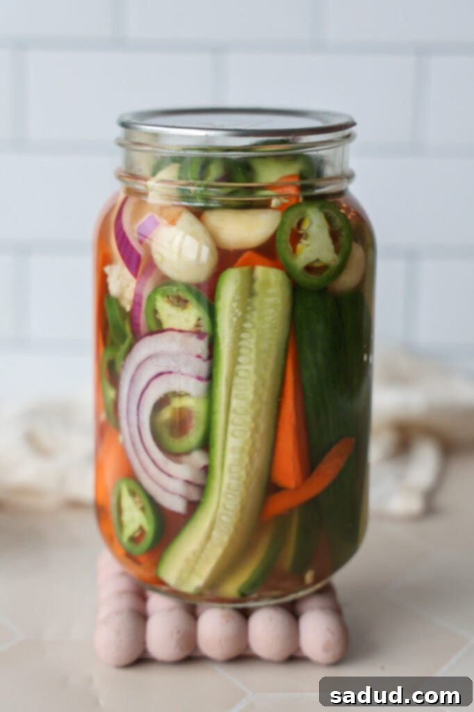A jar of colorful quick pickled vegetables, showcasing their vibrant appearance.