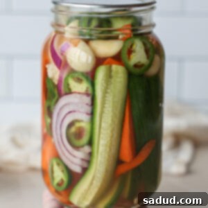 A jar of quick pickled vegetables with ingredients