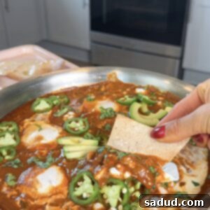 Ranchero Shakshuka 4 A top-down view of the Mexican Shakshuka in a skillet, garnished with fresh toppings.
