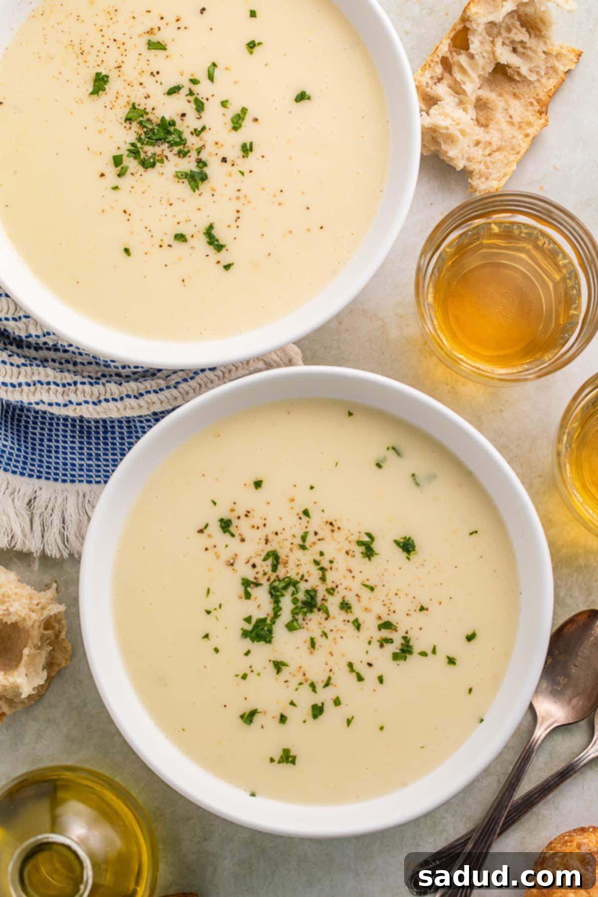 Two bowls of creamy Irish potato soup on a table.