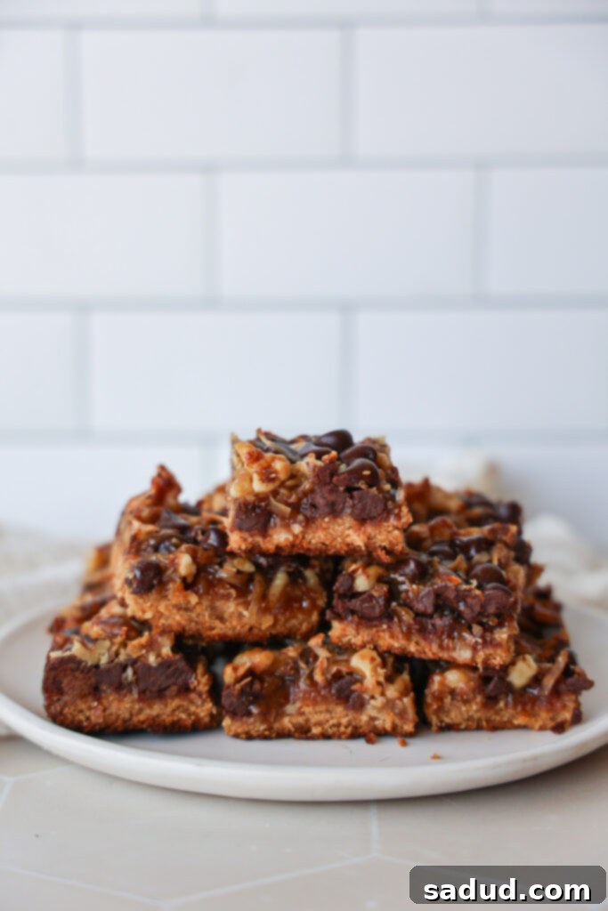 Healthy, gluten-free, vegan magic cookie bars, 7 layer bars, hello dollies ready to eat on a serving plate.
